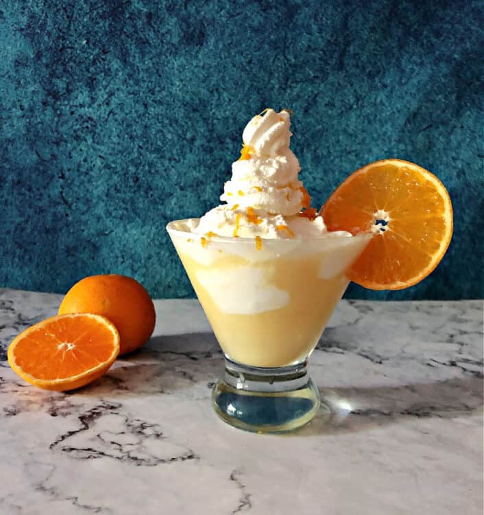 Orange creamsicle martini with an extra-high tower of whipped cream on top