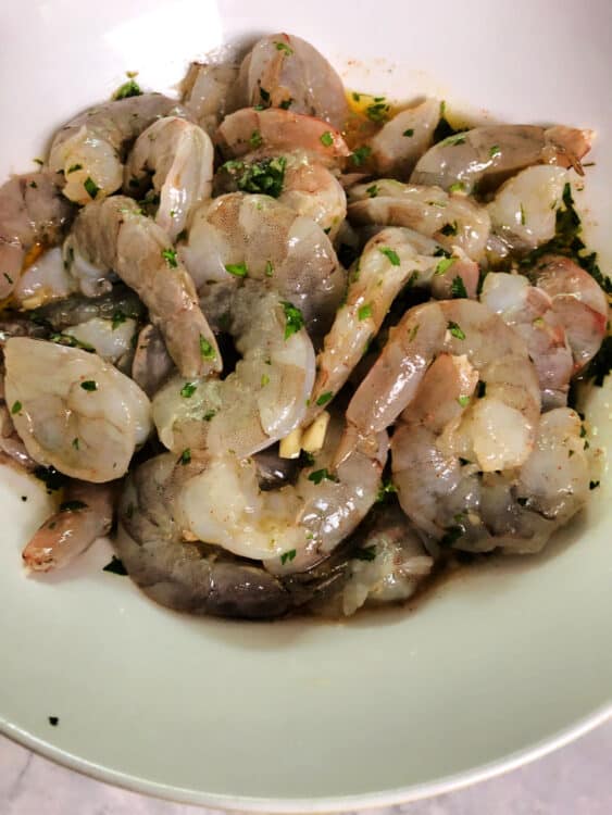 raw shrimp marinating in a bowl