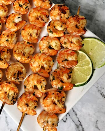 close up of shrimp skewers on a rectangular platter