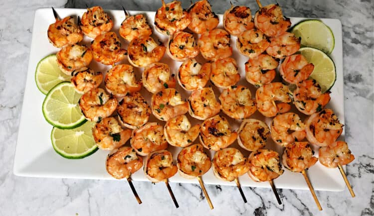 cooked shrimp skewers on a rectangular platter