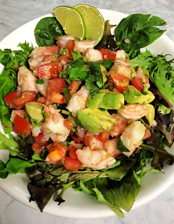 bowl with salad greens topped with shrimp avocado salad