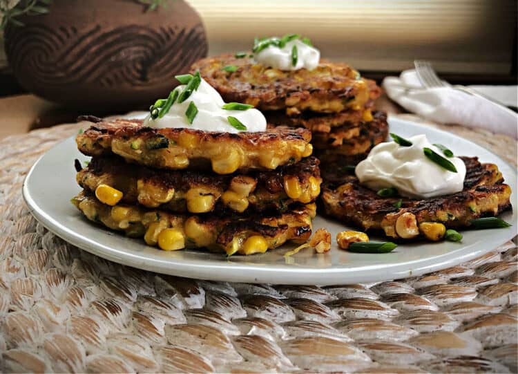 corn fritters with zucchini in a stack on a plate