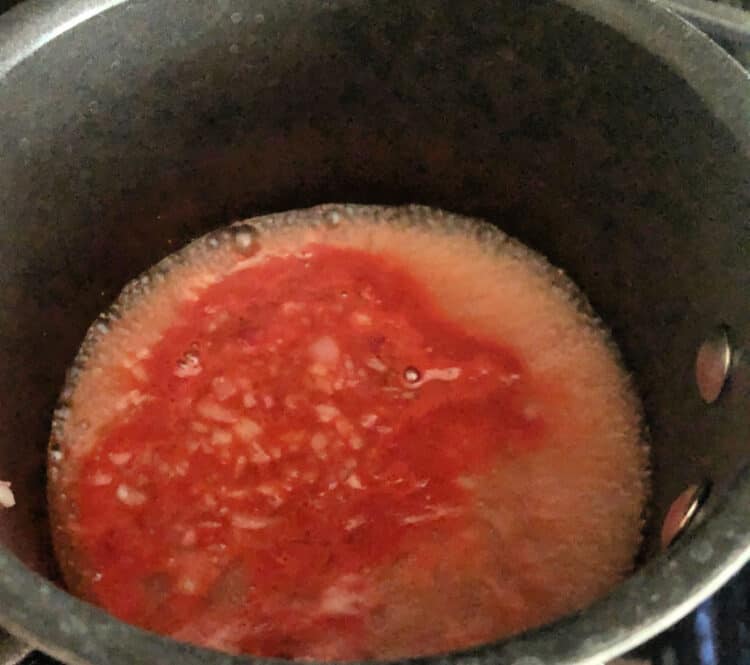 boiling red liquid in  small saucepan