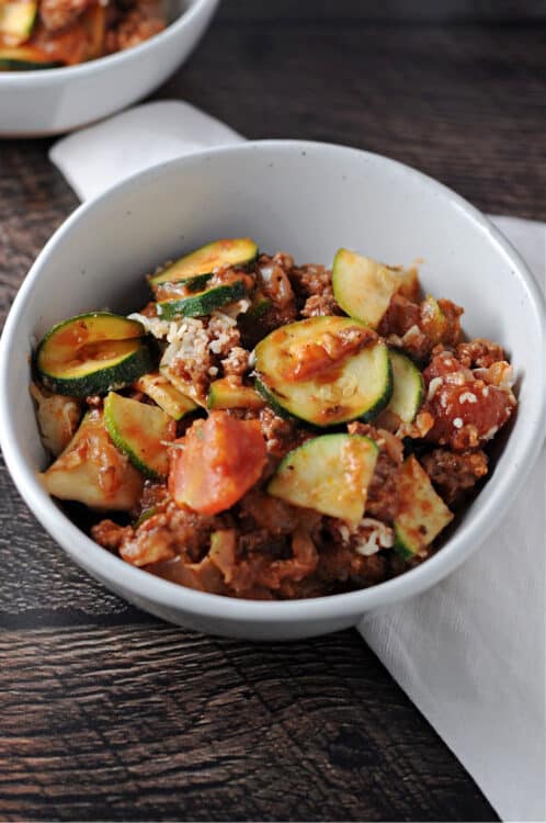 Zucchini casserole with ground beef in a white bowl