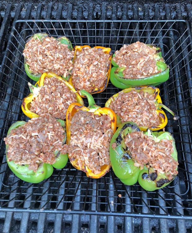 stuffed peppers in a grill basket on the grill