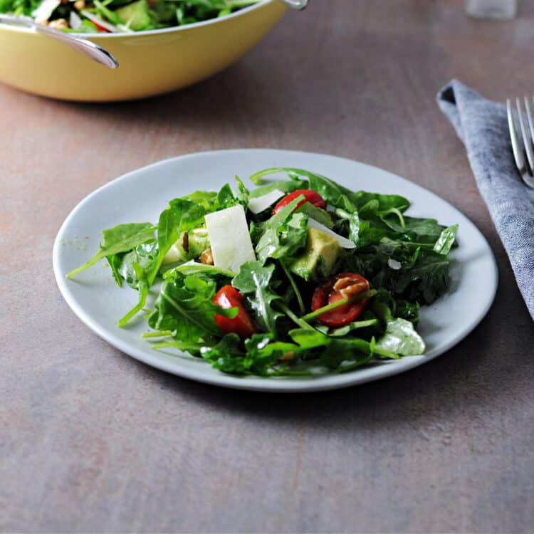 arugula avocado salad on a small plate