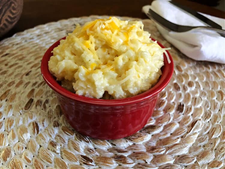 cheesy cauliflower rice in a small red bowl