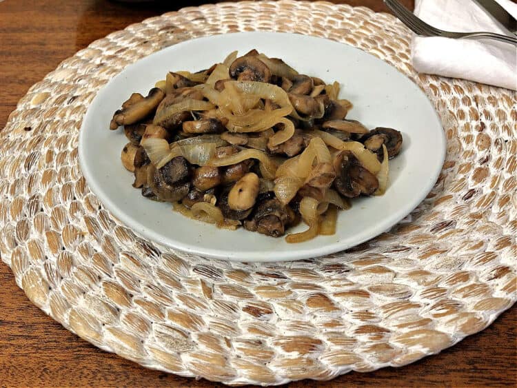 sauteed mushrooms and onions on a small white plate