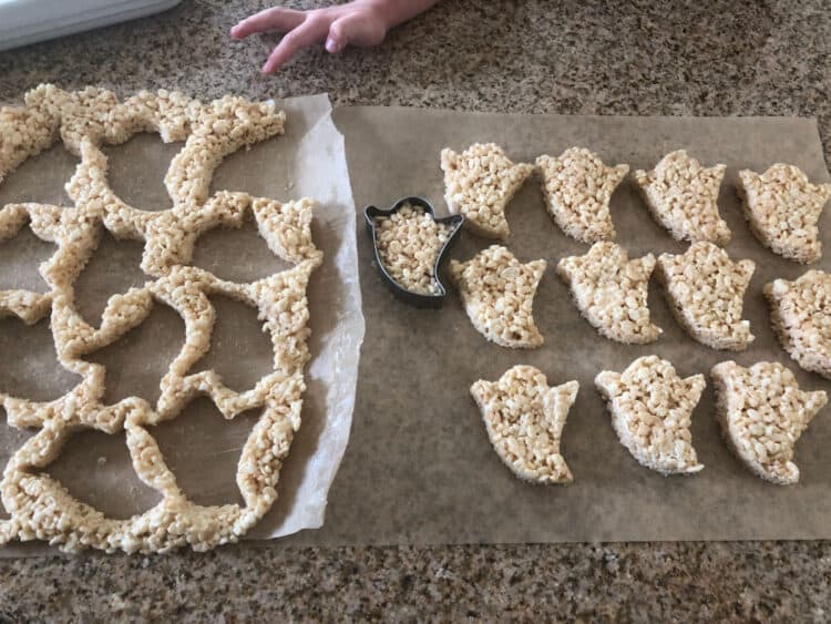 child's hand reaching toward leftover treats, ghost shapes separated from the main