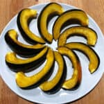 acorn squash crockpot slices arranged on a plate in a circular pattern