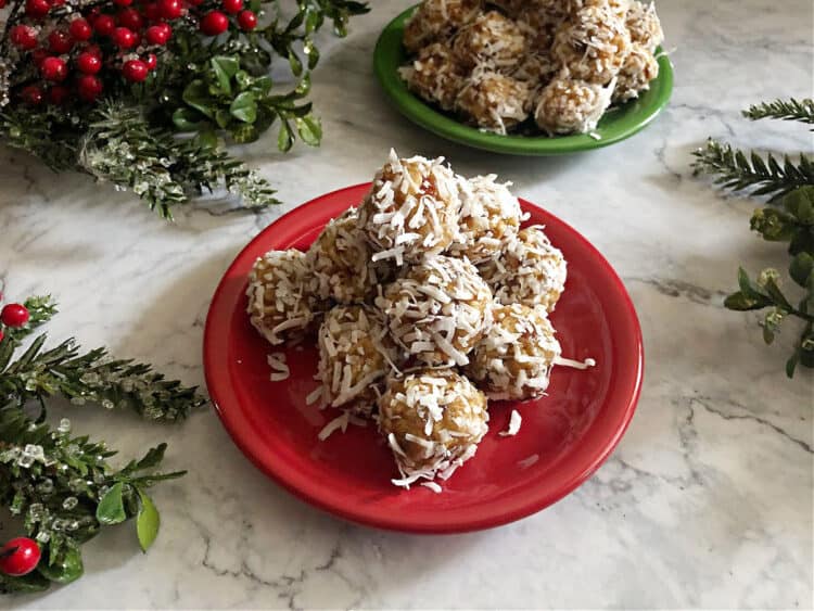 coconut date balls on a small red plate