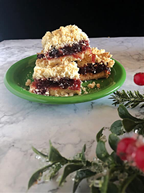 Plate of bars behind some Christmas greens and holly