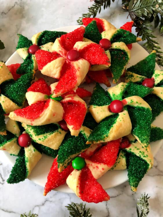 plate full of green and red poinsettia cookies