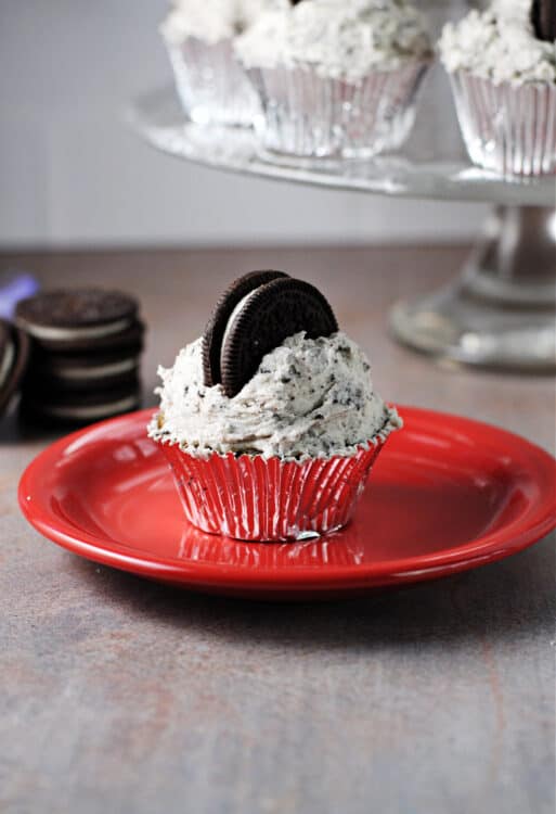 Oreo Cupcake frosted with oreo buttercream on a red plate.