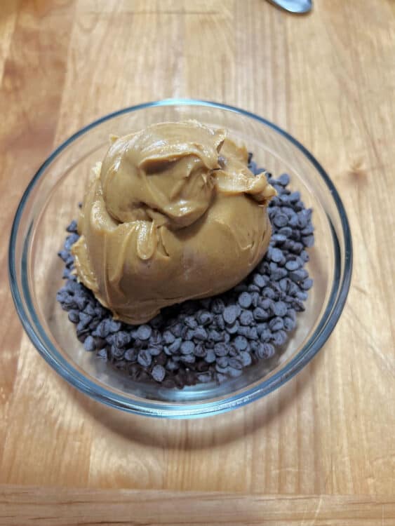 chocolate chips and peanut butter in a glass bowl