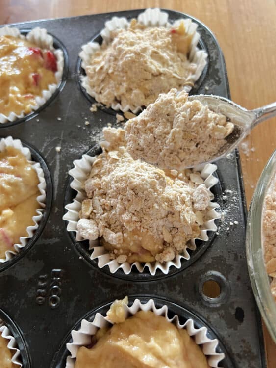 sprinkling streusel on top of each unbaked muffin.