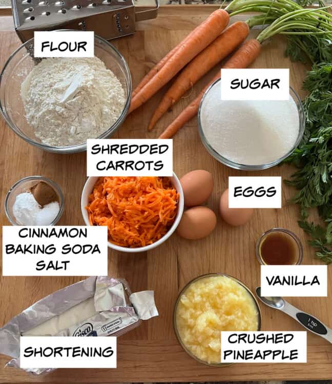 ingredients: flour, sugar, shredded carrots, eggs, crushed pineapple, vanilla, shortening, cinnamon, baking soda, and salt.