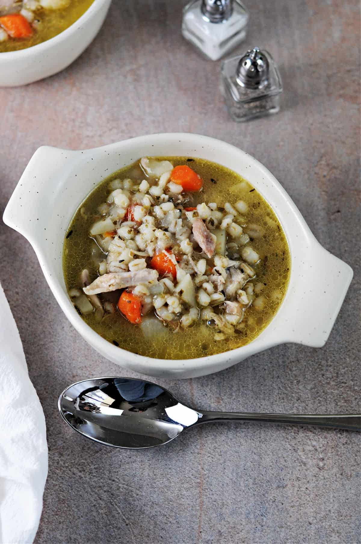 bowl of instant pot chicken and barley soup.