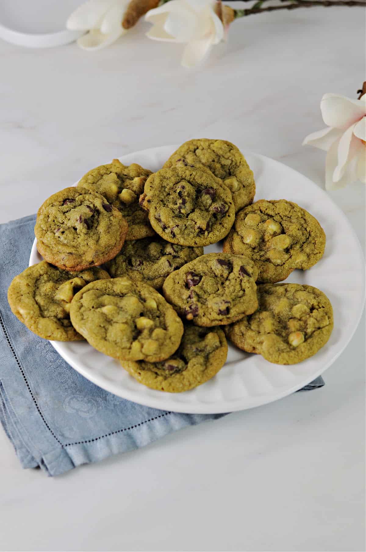Matcha chocolate chip cookies served on a white plate.