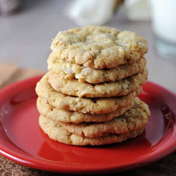 stack of oatmeal coconut cookies on a small red plate.