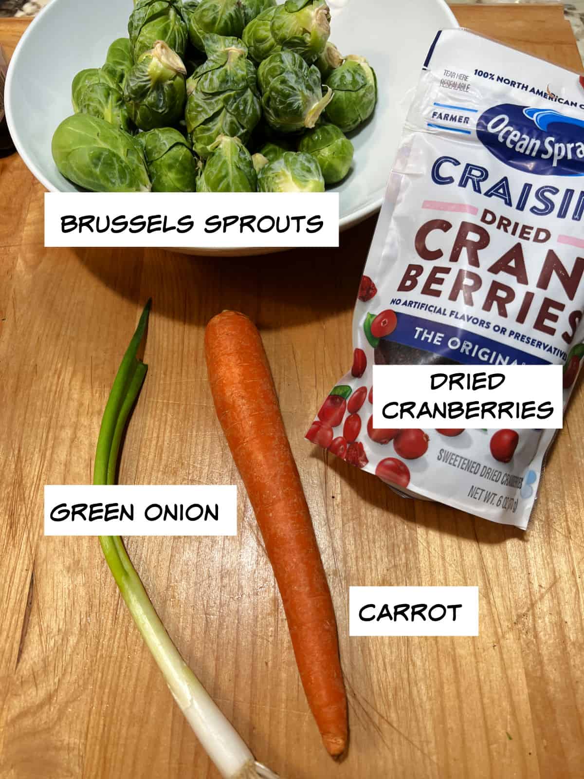 ingredients: brussels sprouts, craisins, carrot, and green onion.