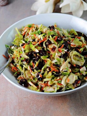 serving bowl full of brussels sprout and cranberry salad