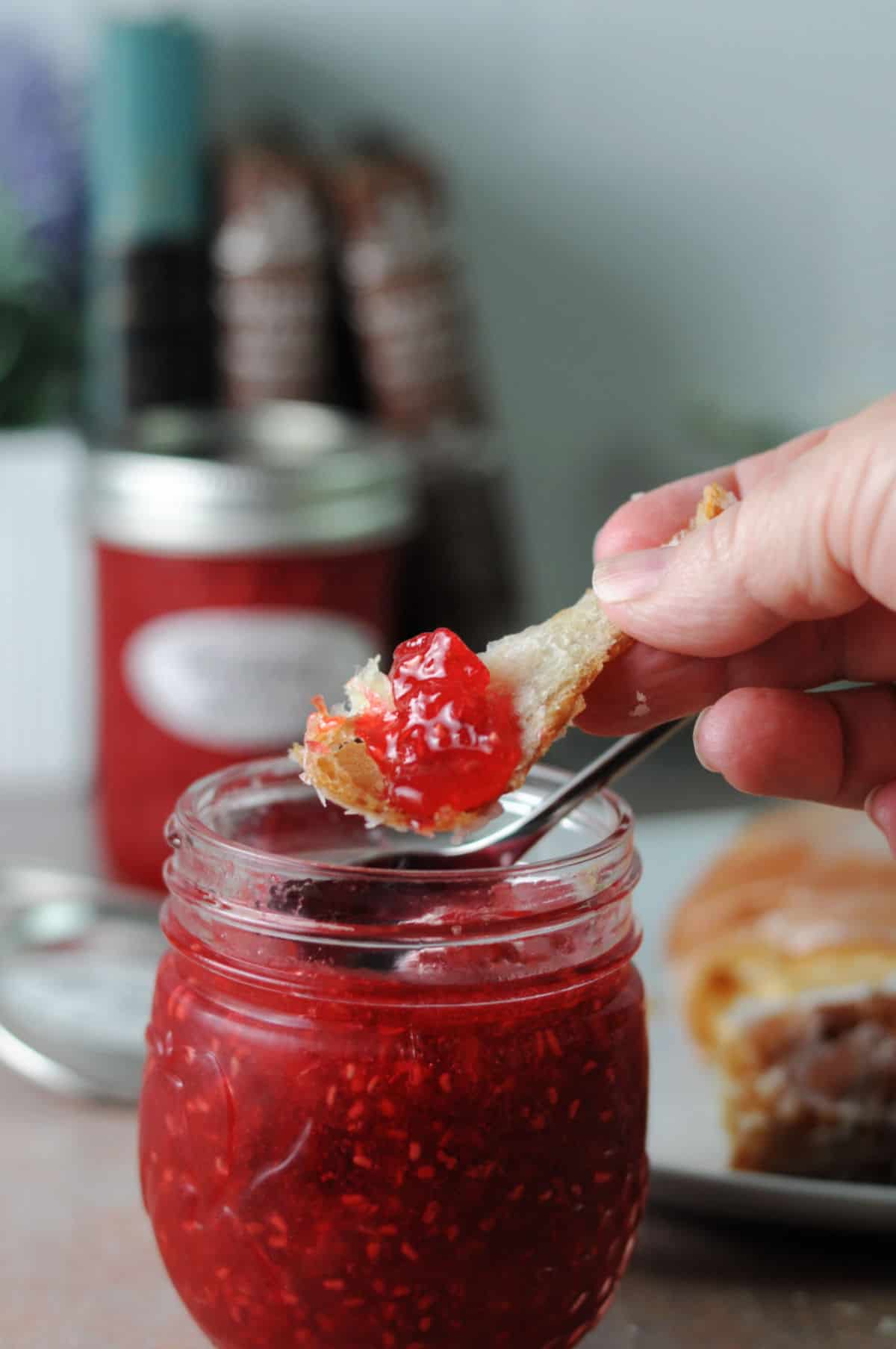 raspberry jam on a small piece of pastry.