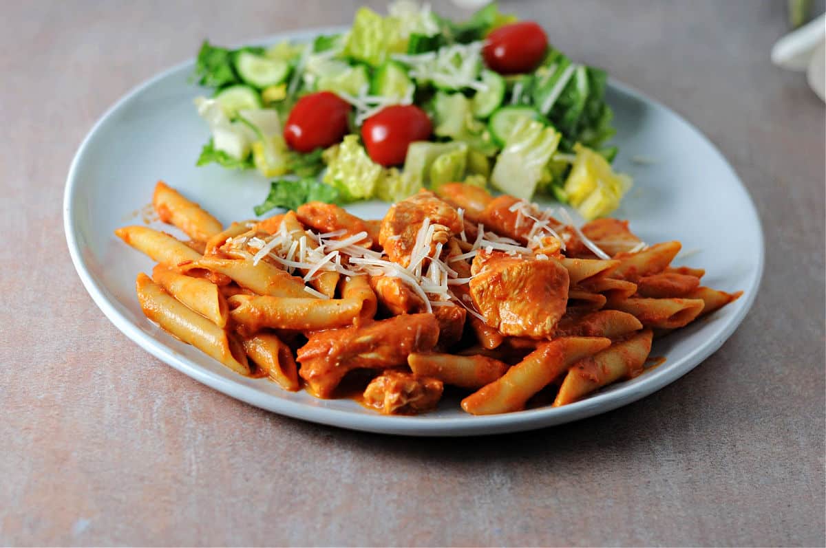 plate of penne alla vodka sauce with chicken.