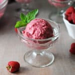 scoop of raspberry nice cream in a dessert glass.