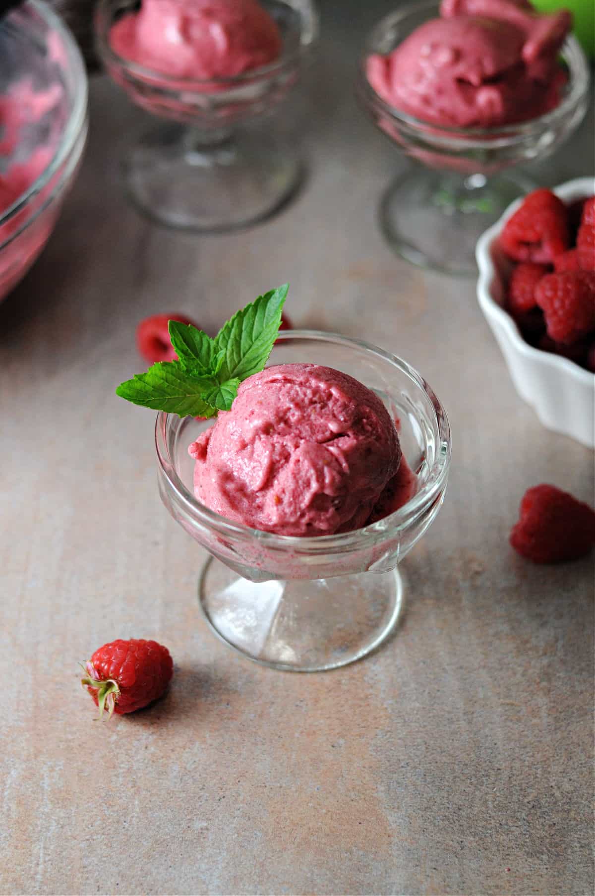 top down view of a scoop of raspberry nice cream in a dessert cup.