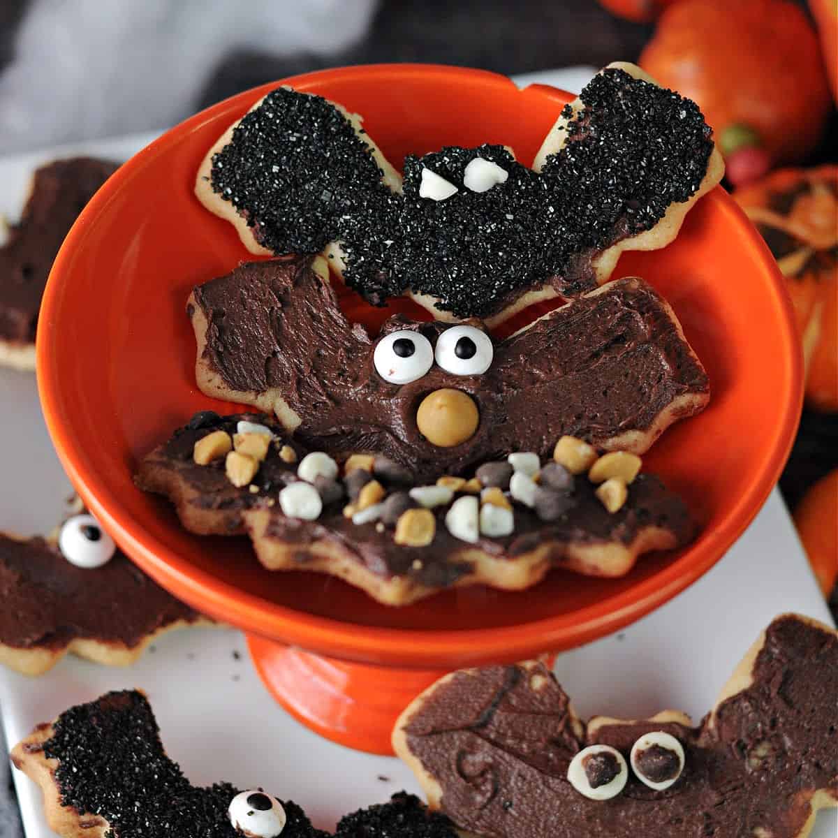 3 bat sugar cookies on a small orange dish.