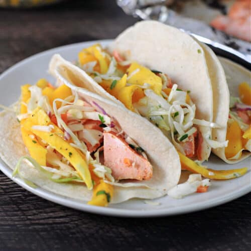 bbq salmon tacos with mango slaw on a small plate
