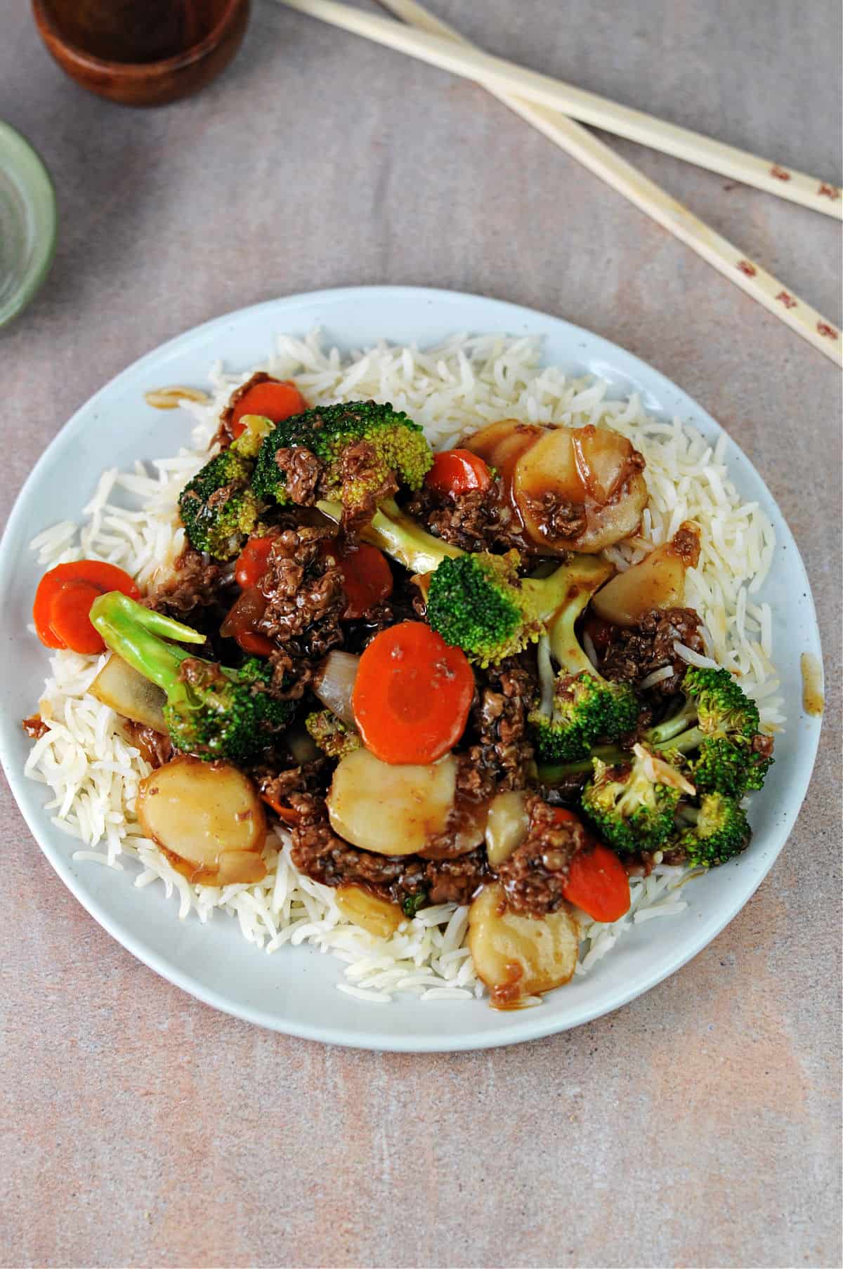 plate of shaved beef and broccoli on white rice.
