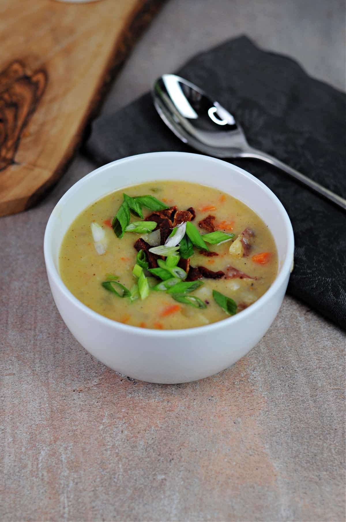 cheesy potato soup in a white bowl.