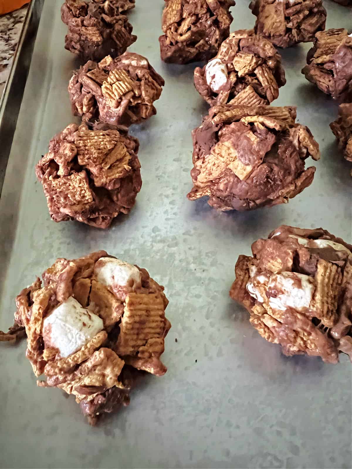paper lined sheet of formed s'mores cookies.