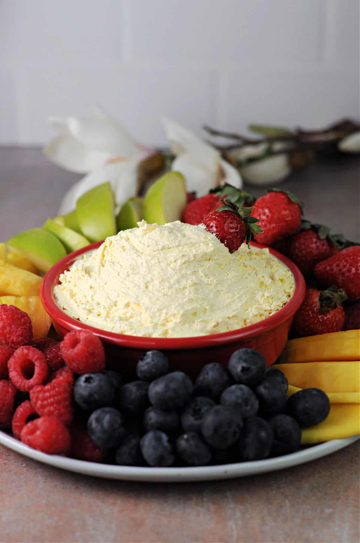 Cool Whip dip surrounded by fruit.