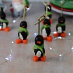 group of penguin appetizers surrounded by twinkle lights.