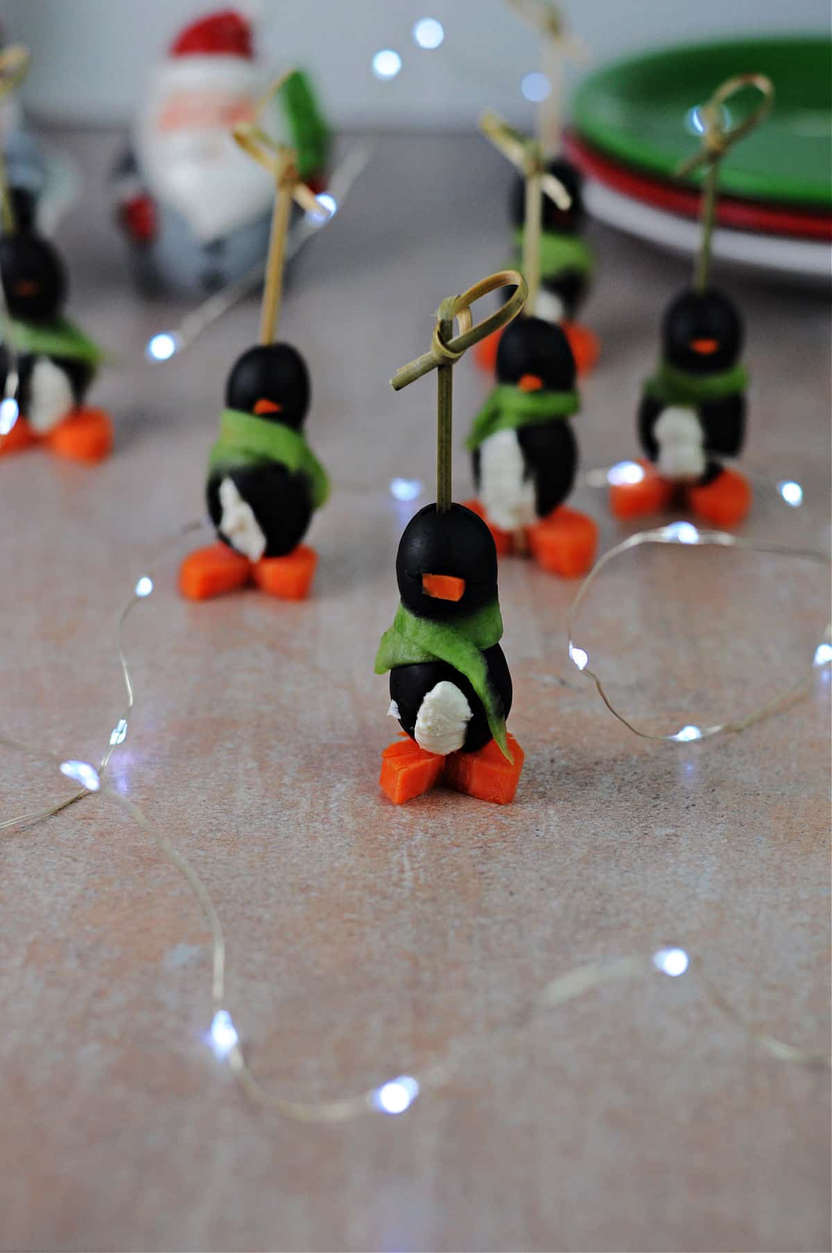 Cream Cheese Penguin appetizers surrounded by twinkle lights