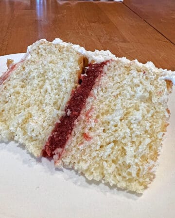 slice of vanilla cake with strawberry filling.