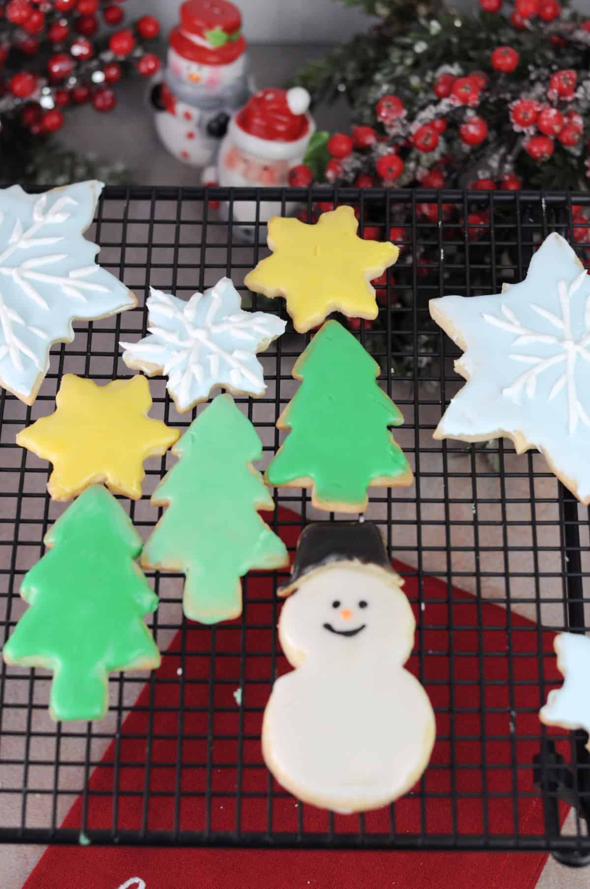 an assortment of decorated cut out sugar cookies made from no chill dough, drying on a wire rack.