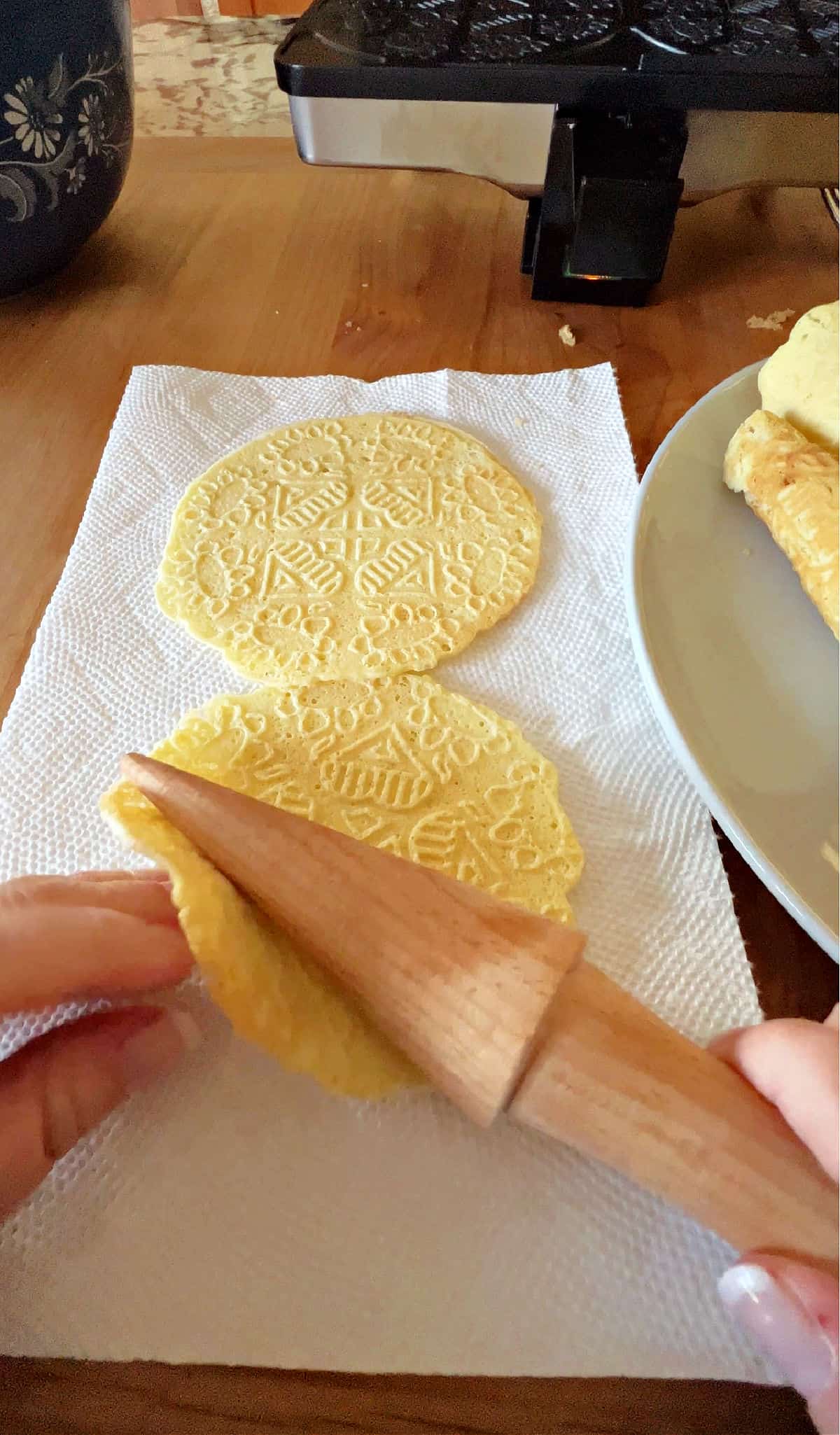 rolling the warm cookie with the special wooden tool.