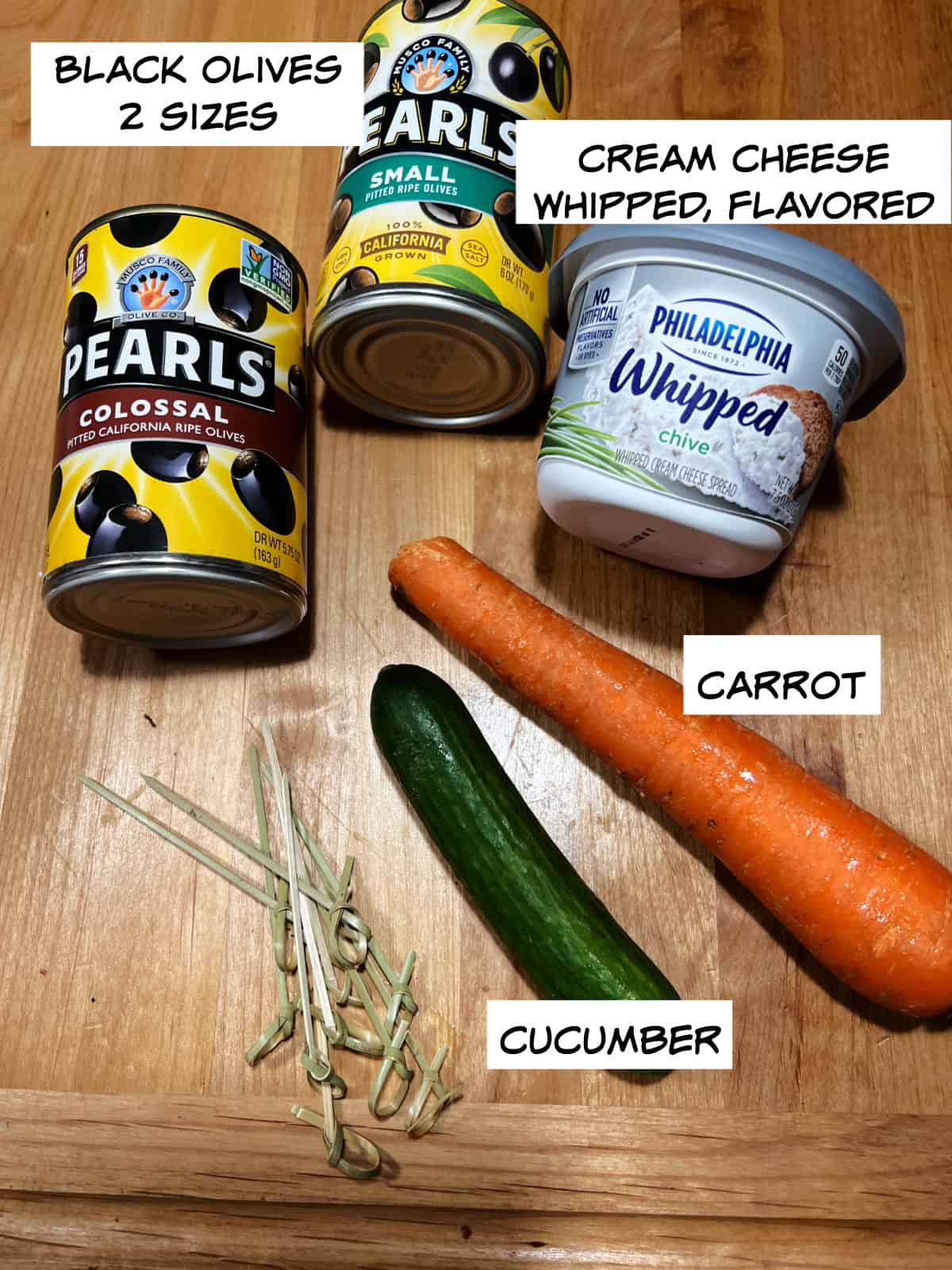 ingredients: olives, whipped cream cheese, carrot, and cucumber.