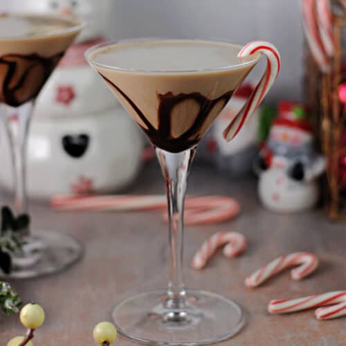 chocolate peppermint martini garnished with a candy cane.