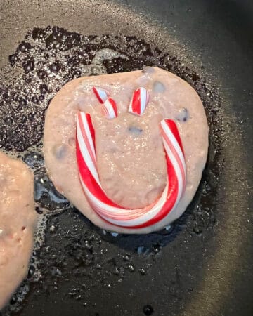 peppermint pancakes cooking in a pan.