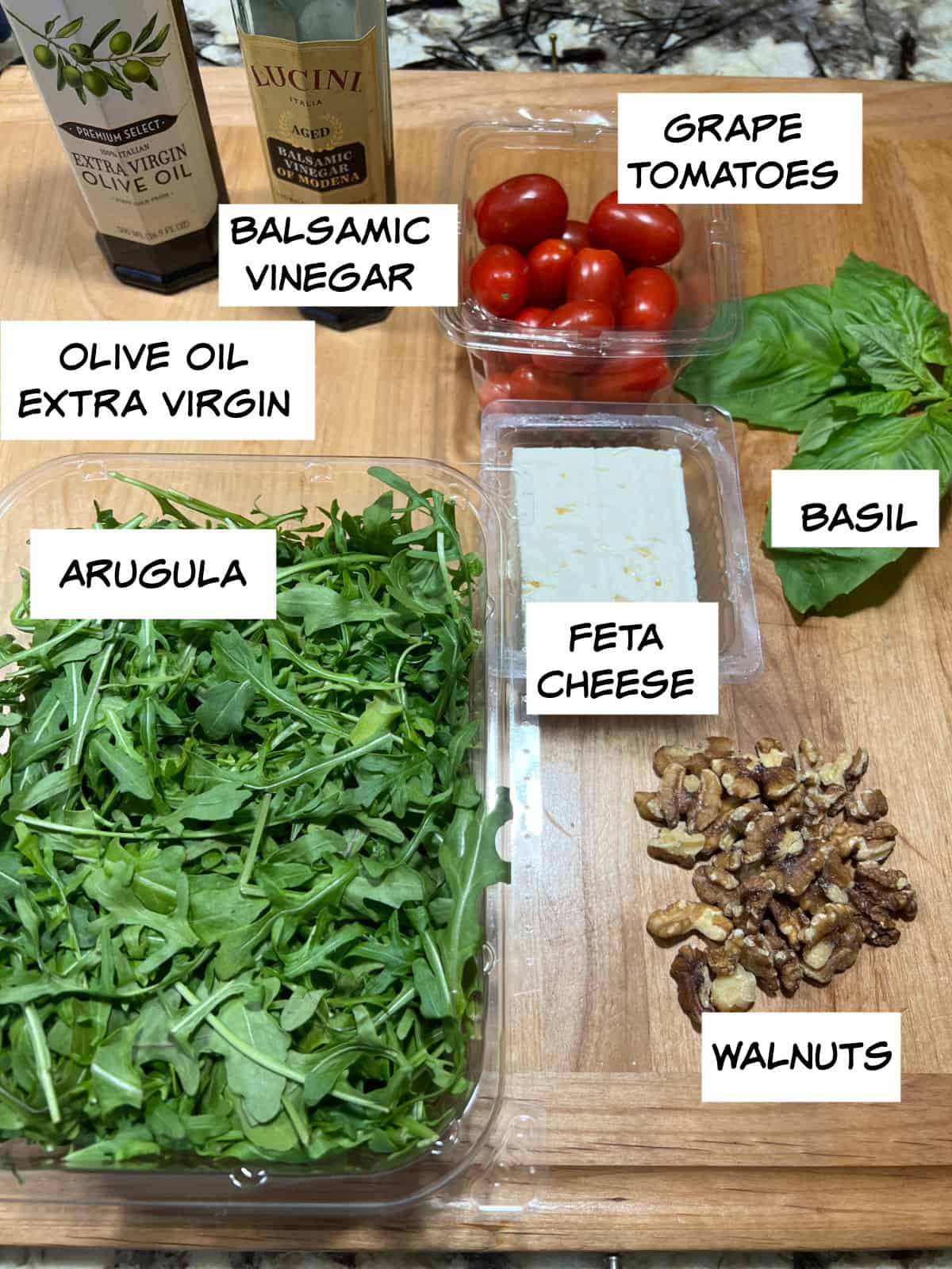 ingredients: arugula, olive oil, balsamic vinegar, tomatoes, basil, feta cheese, and walnuts.