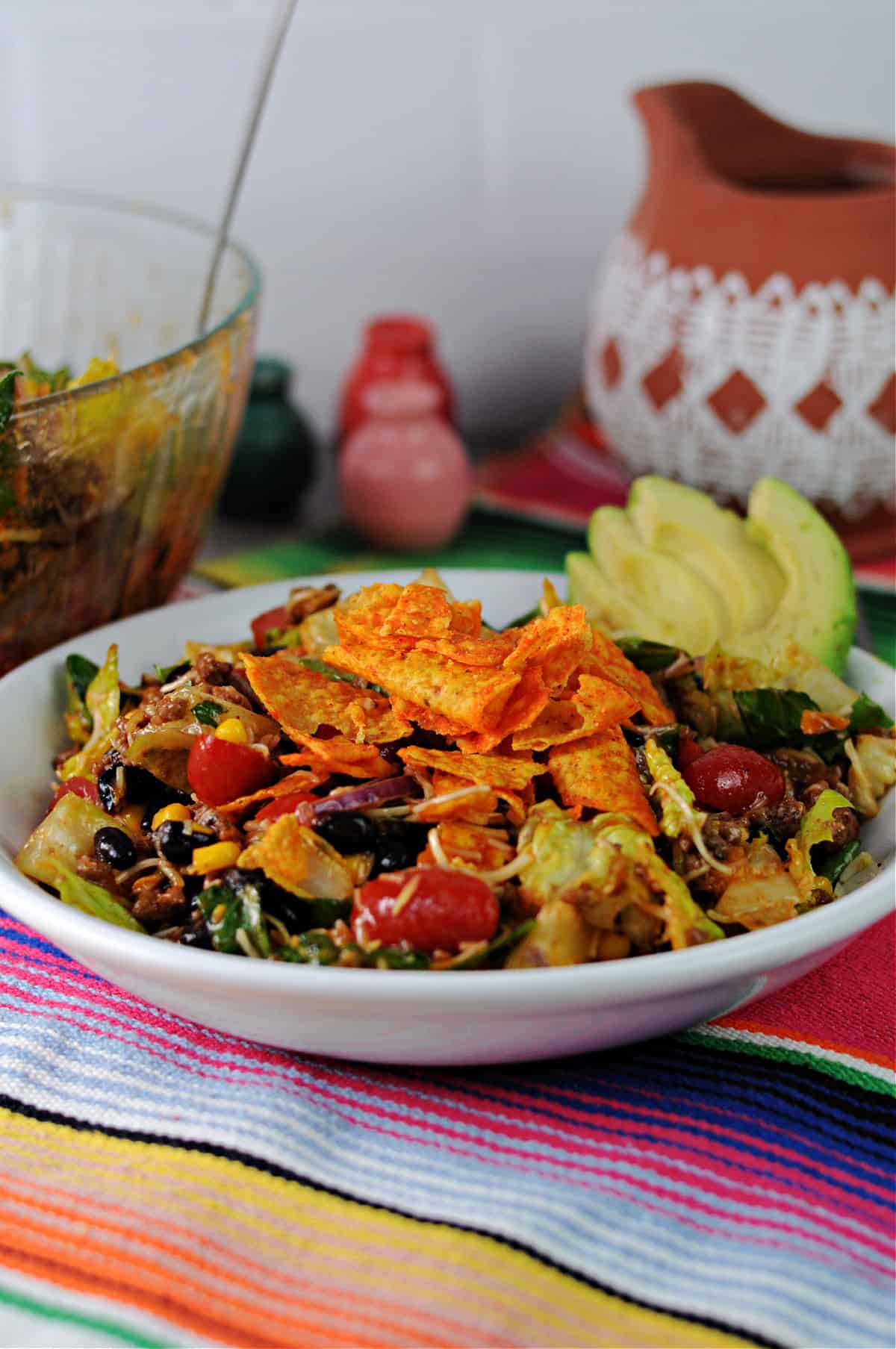 serving of taco salad with Doritos added on top.