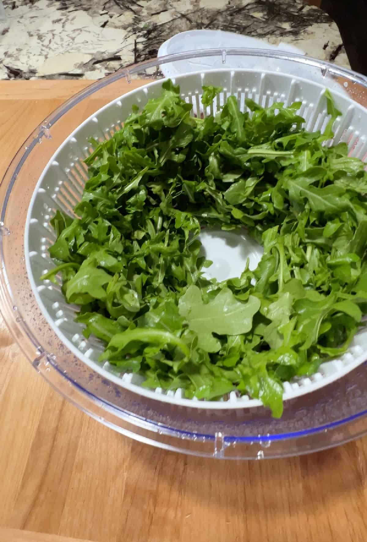 washed greens in a salad spinner.