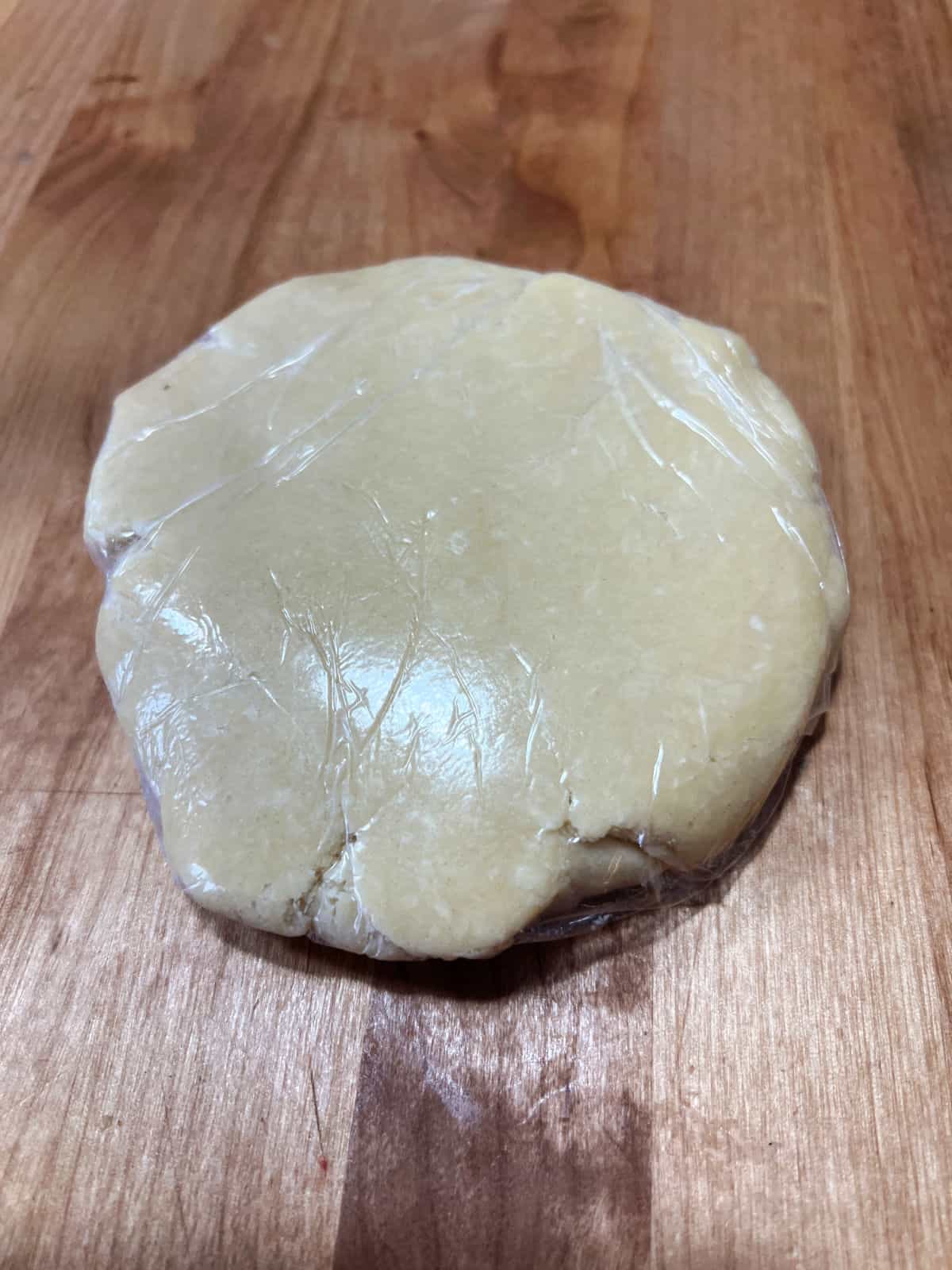 pie crust dough in platic wrap.