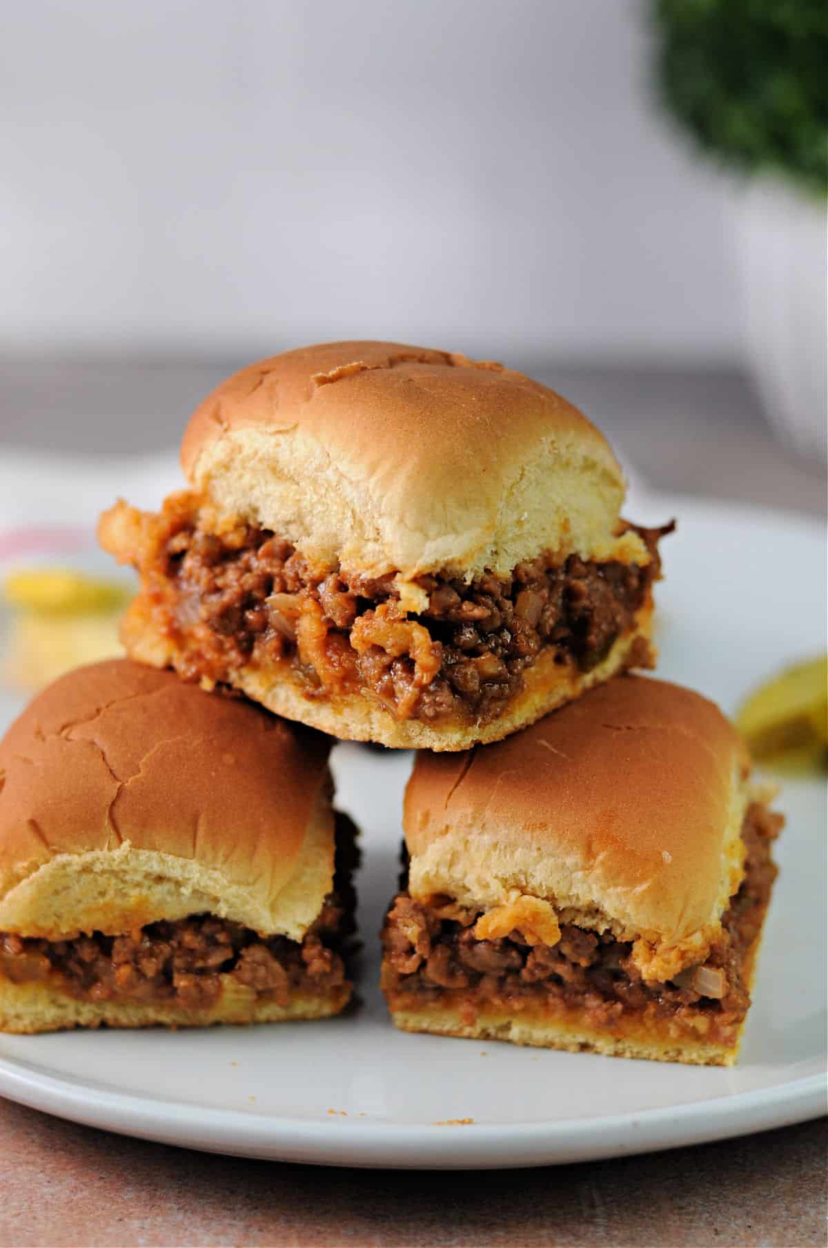 3 sloppy joe sliders on a plate.