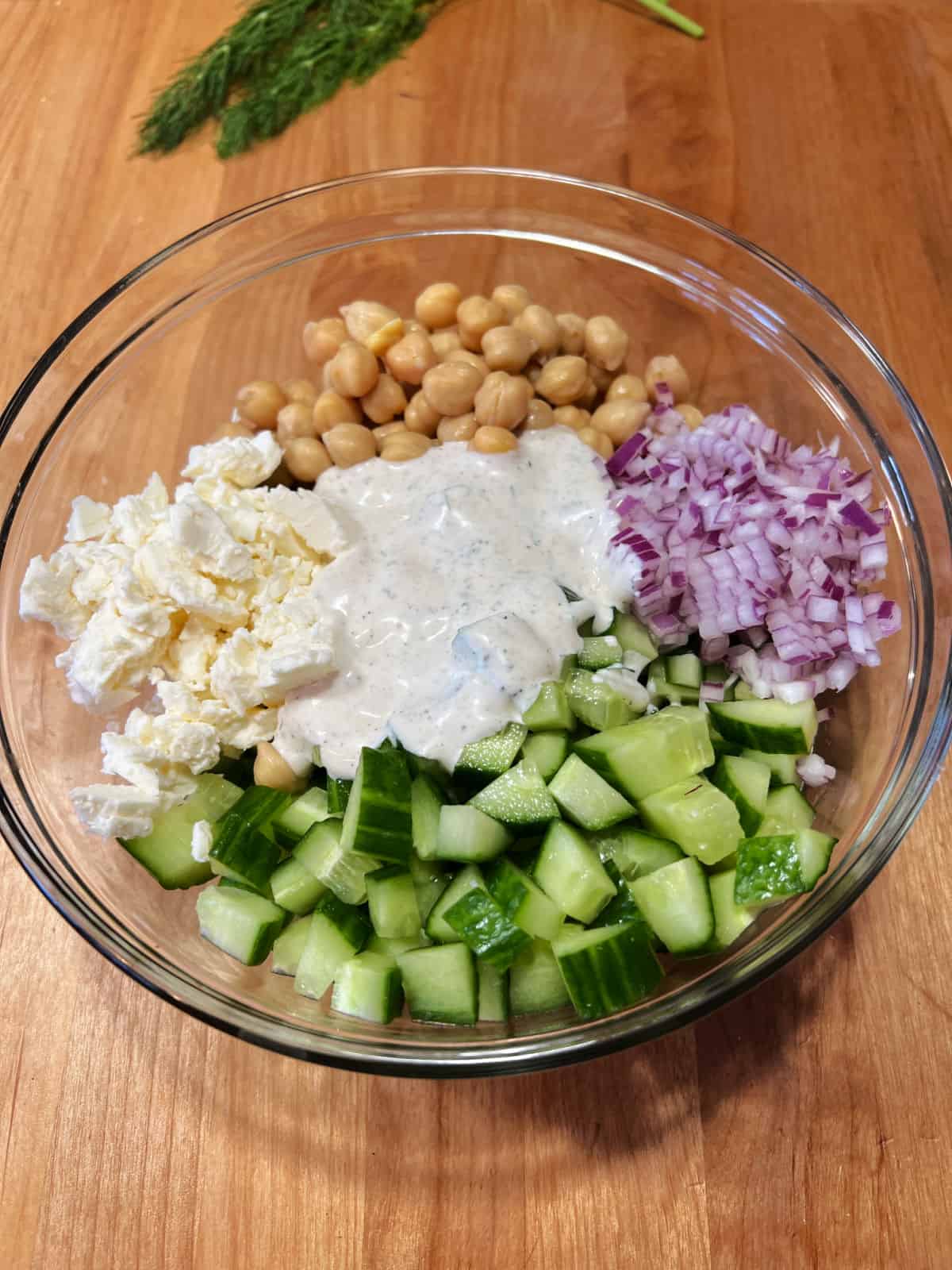 dressing added to salad, ready to be mixed.